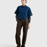 JONES + CO Fort Top in muddy indigo denim worn over a patterned shirt and brown trousers by a model