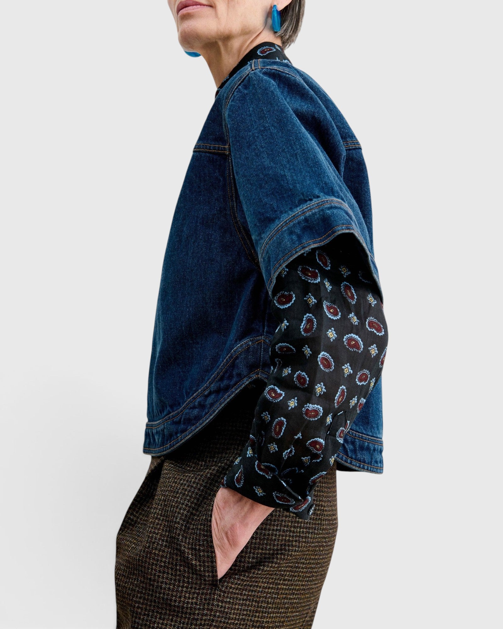 JONES + CO Fort Top in muddy indigo denim with a boxy silhouette, layered over a patterned long-sleeve shirt.