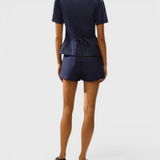 JONES + CO navy linen vest with cap sleeves and back tie detail worn with matching shorts, back view