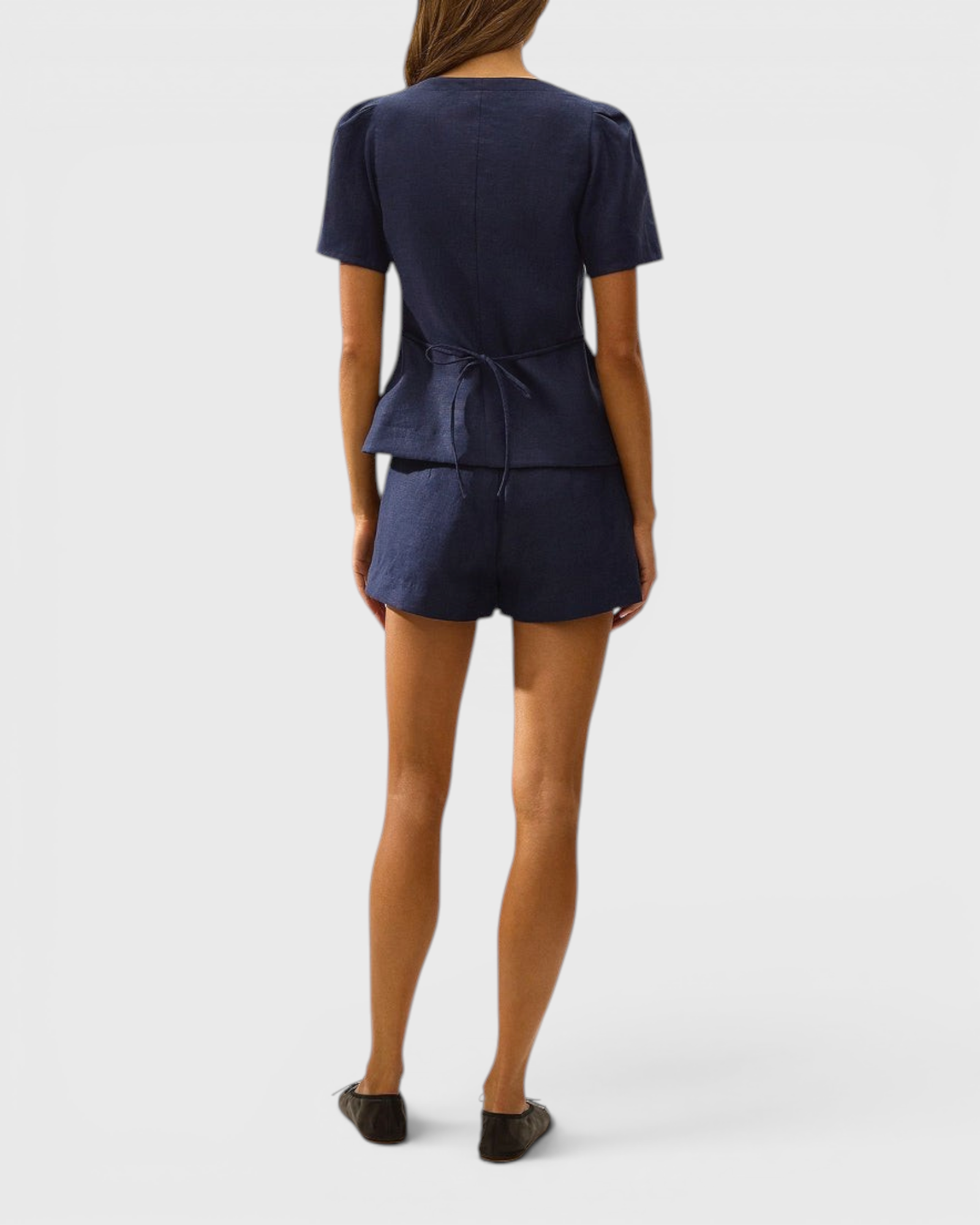 JONES + CO navy linen vest with cap sleeves and back tie detail worn with matching shorts, back view