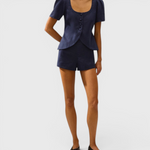 JONES + CO Emma vest in navy linen with scoop neckline, button front, and cap sleeves worn with matching shorts