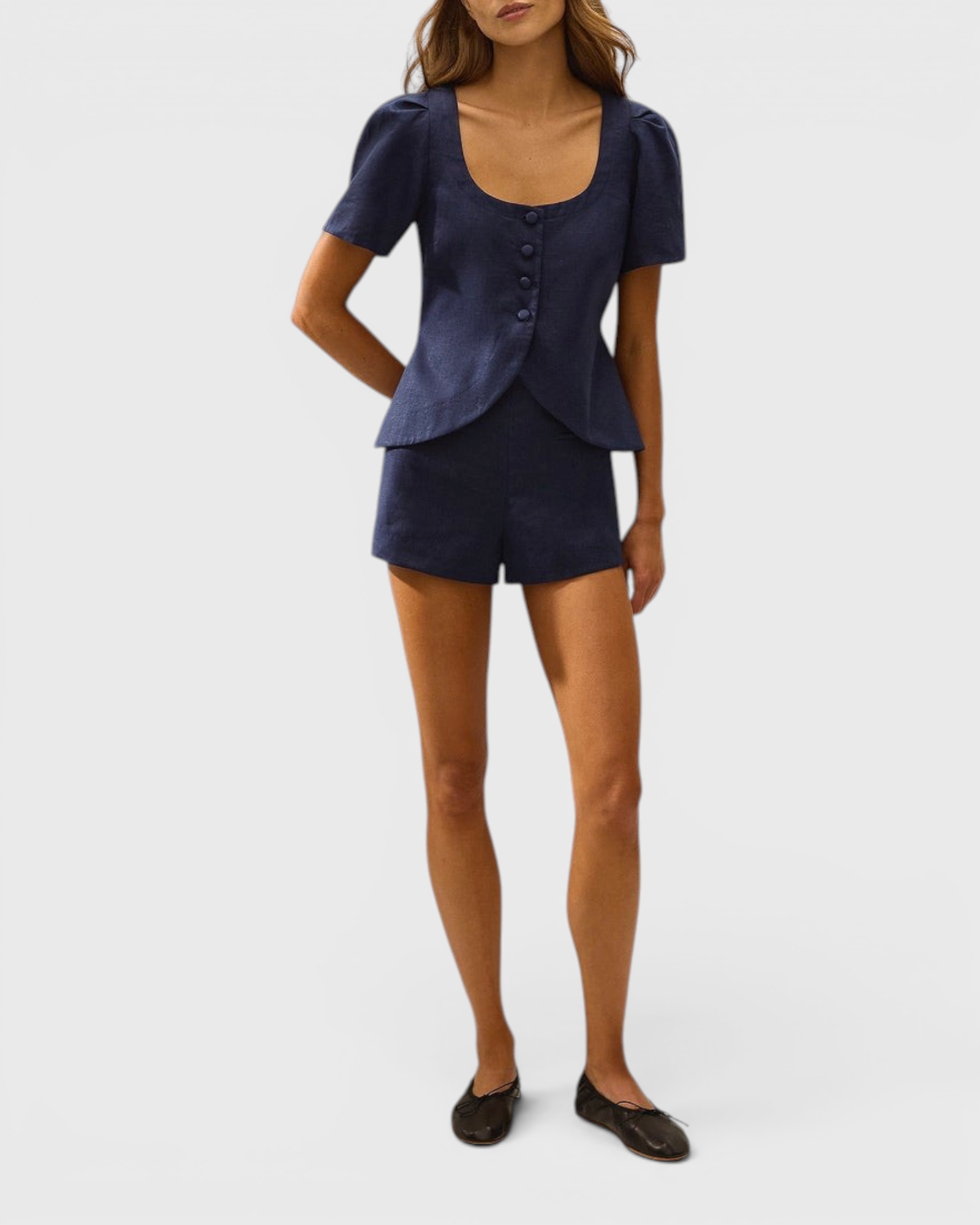 JONES + CO Emma vest in navy linen with scoop neckline, button front, and cap sleeves worn with matching shorts