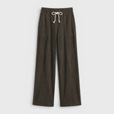 JONES + CO Noa straight-leg French terry pants in dark olive with a rope drawstring waist and deep side pockets.
