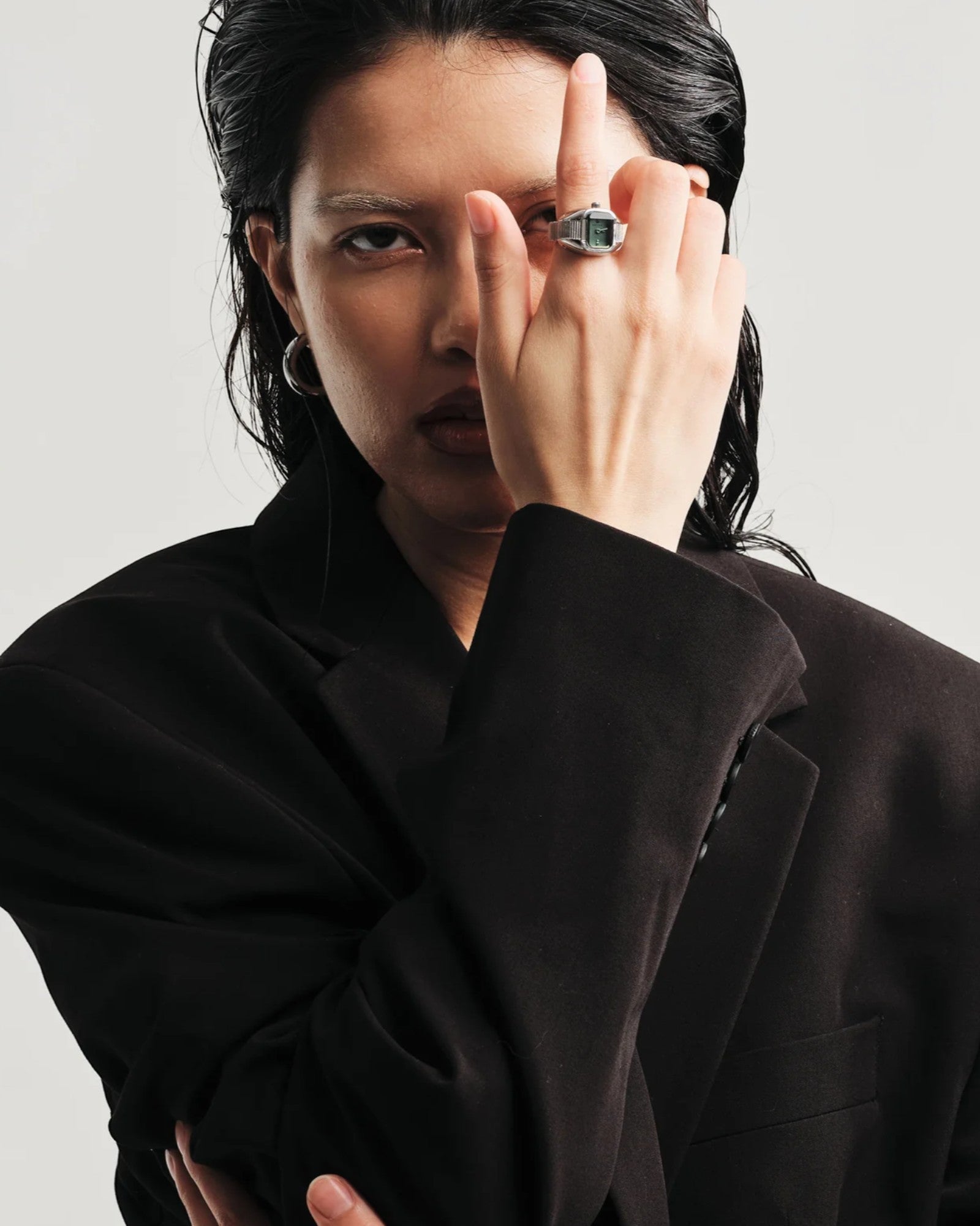 JONES + CO Nocturne Time Ring in silver with smoke crystal worn by a model in a black blazer
