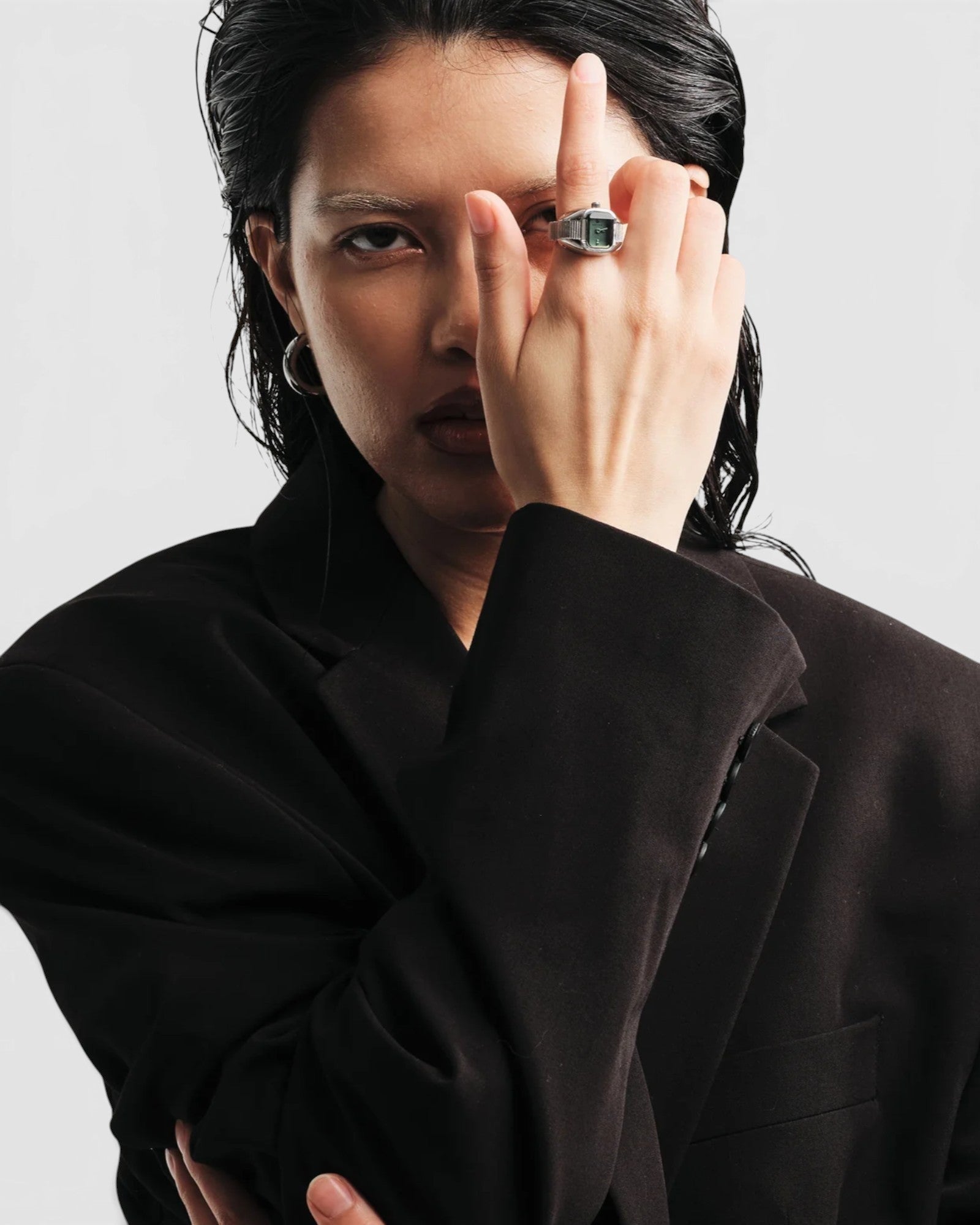 JONES + CO Nocturne Time Ring in silver with a smoke-colored crystal worn on a model in a black blazer.