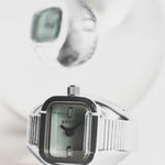 JONES + CO BREDA Nocturne Time Ring featuring a silver stainless steel rectangular case and smoke-colored crystal.
