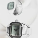 JONES + CO BREDA Nocturne Time Ring featuring a silver stainless steel rectangular case and smoke-colored crystal.