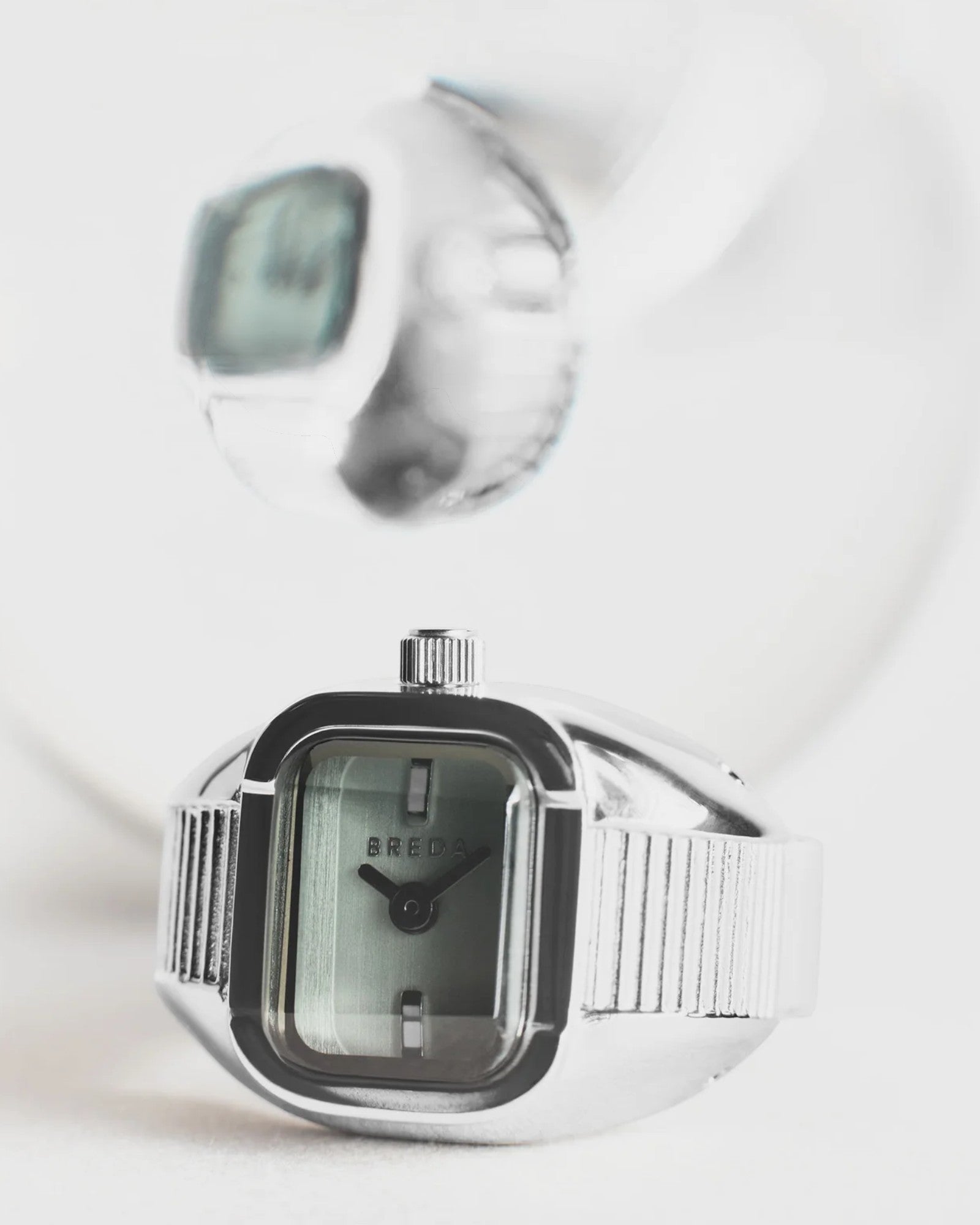 JONES + CO BREDA Nocturne Time Ring featuring a silver stainless steel rectangular case and smoke-colored crystal.