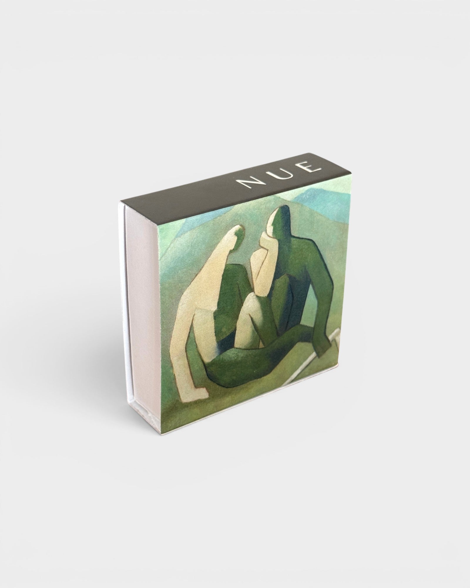 JONES + CO Nue matchbox featuring artistic green and blue abstract figures on a double-sided cardboard box.