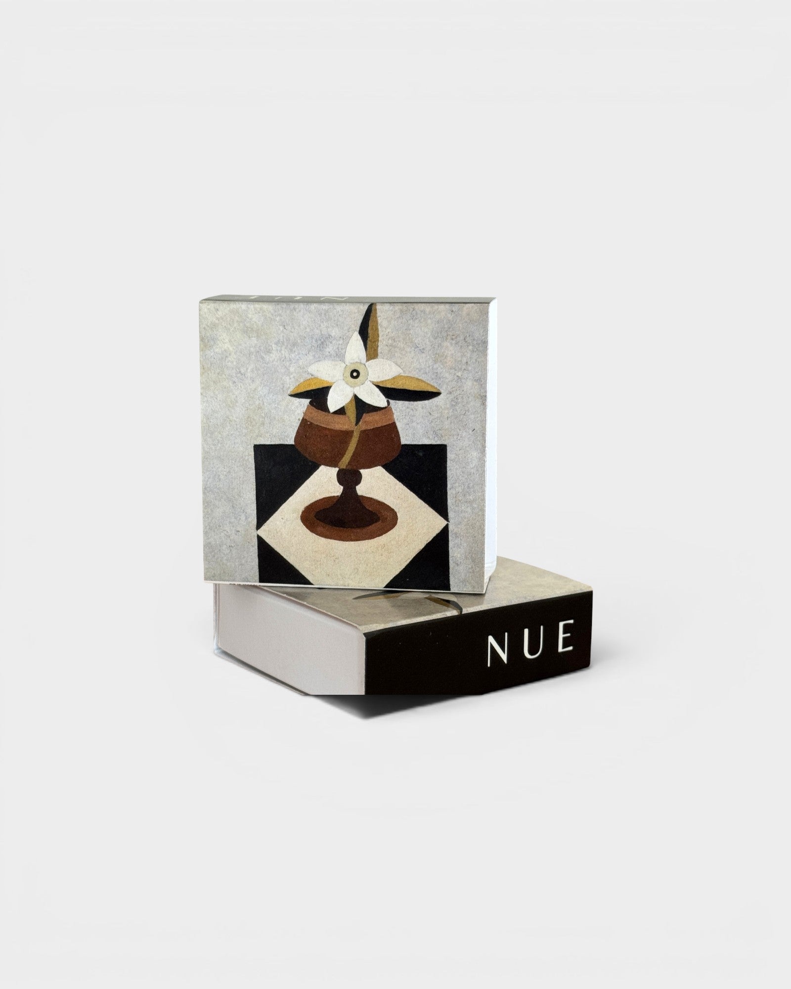 JONES + CO Nue matchbox featuring artistic floral illustration on a checkered surface with 100 matches included