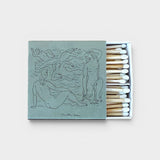 JONES + CO Nue matchbox featuring a sage green cover with artistic line drawings of figures and white-tipped matches.
