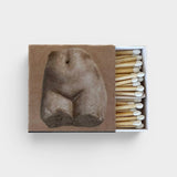 JONES + CO Nue matchbox featuring a classical stone torso sculpture print, containing wooden matches with white tips.