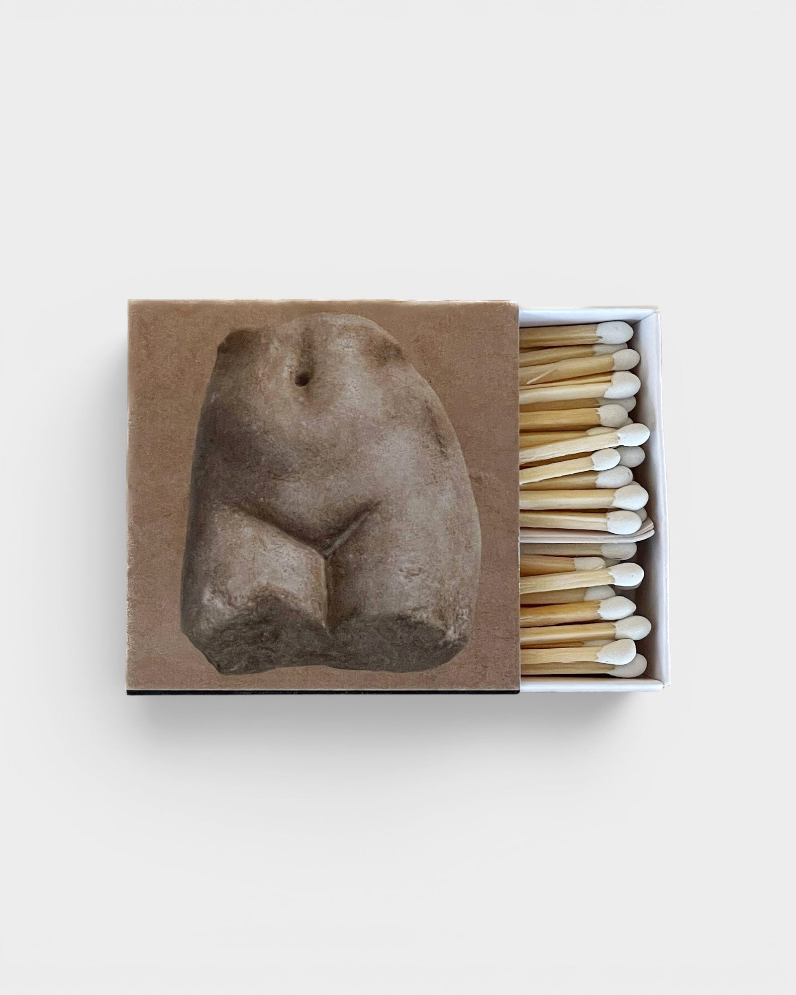 JONES + CO Nue matchbox featuring a classical stone torso sculpture print, containing wooden matches with white tips.
