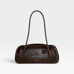 JONES + CO Oyster shoulder bag in espresso brown pebbled leather with a sleek, elongated silhouette.