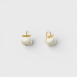 JONES + CO statement pebble pearl earrings in white with 14k gold over brass handmade ear wires on a light background.