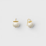 JONES + CO statement pebble pearl earrings in white with 14k gold over brass handmade ear wires on a light background.