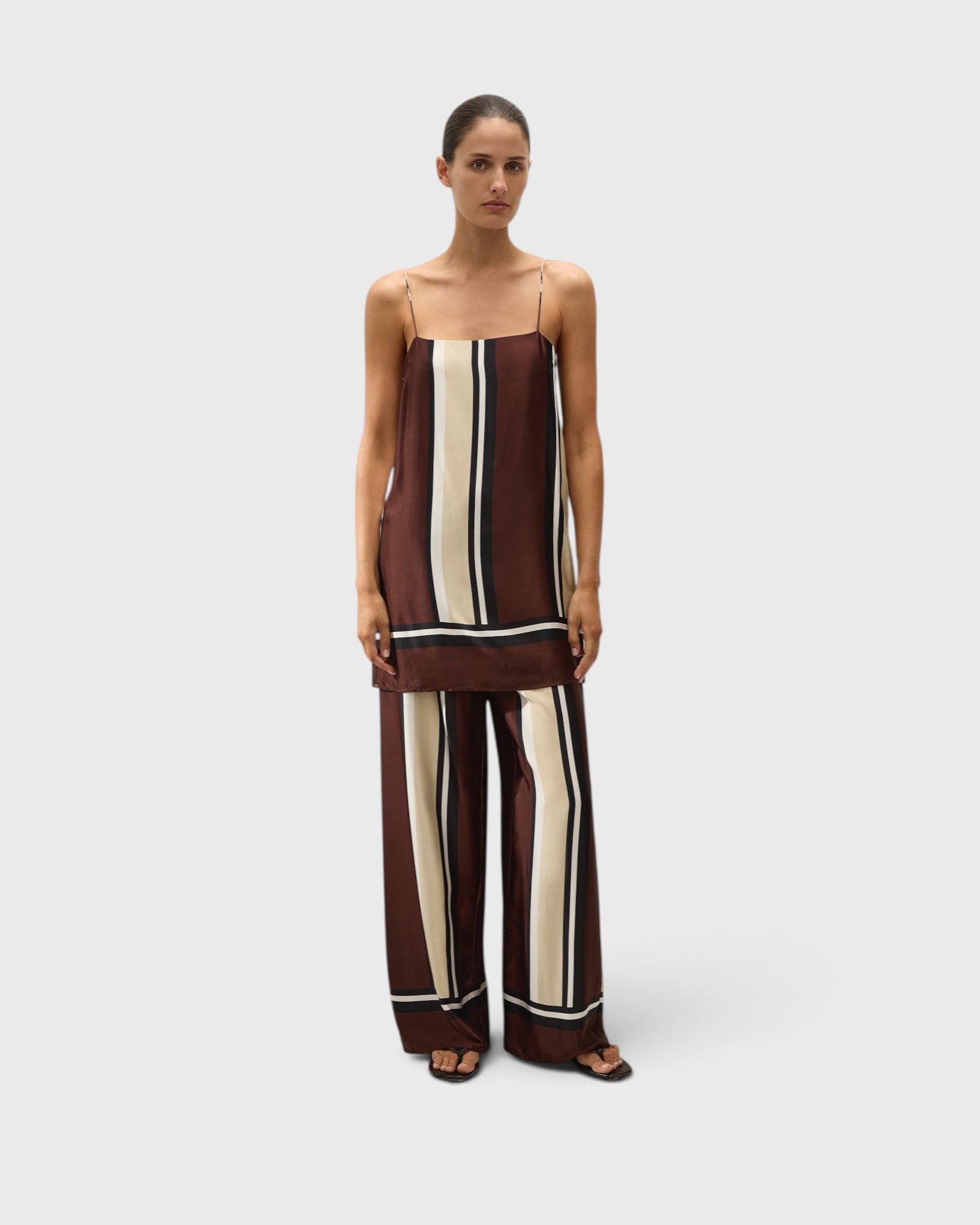 JONES + CO Phylis mini slip dress in Sintra stripe viscose satin with adjustable straps on a model