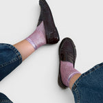 JONES + CO pink laminated net socks worn with dark brown loafers and blue jeans