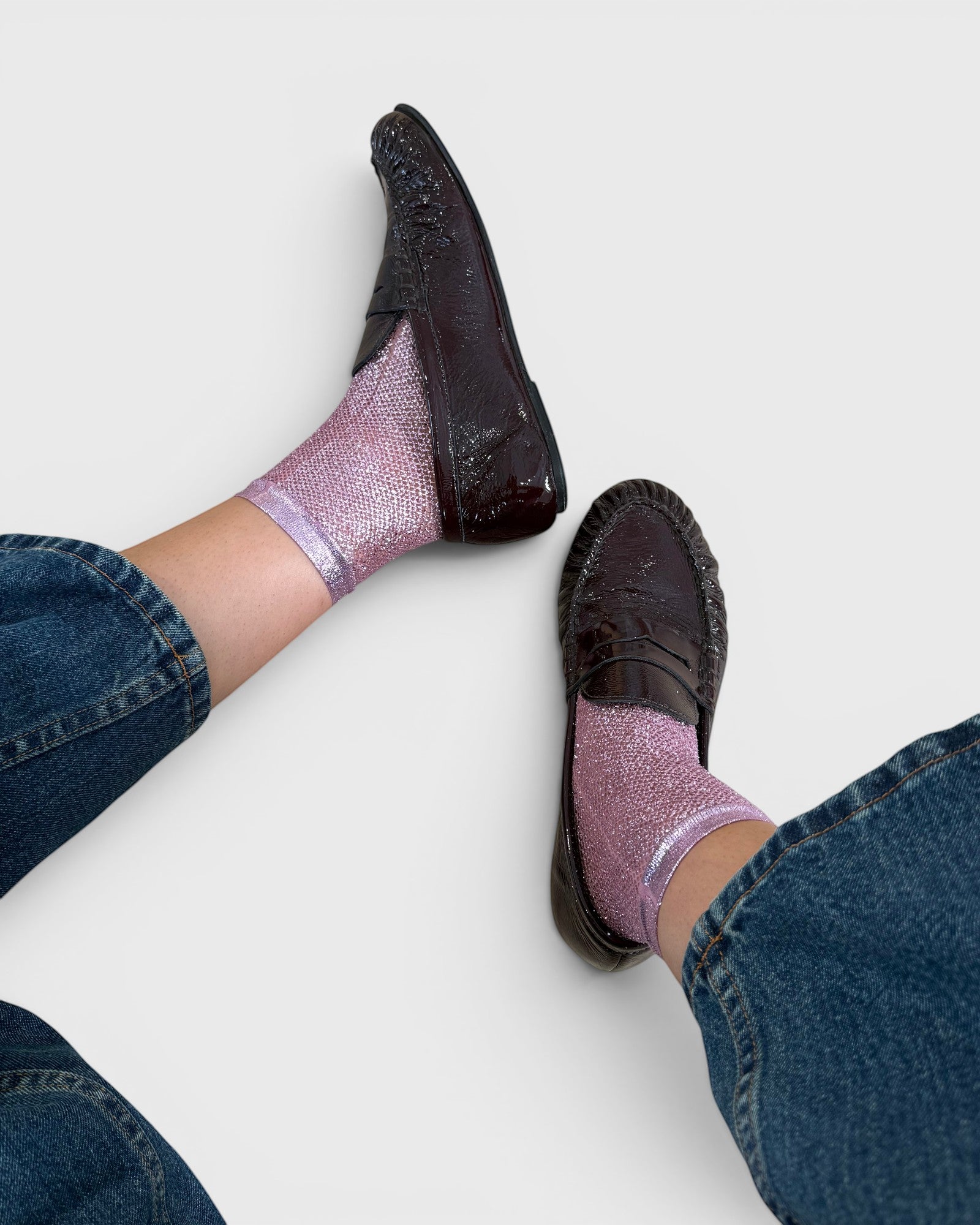 JONES + CO pink laminated net socks worn with dark brown loafers and blue jeans