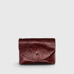 JONES + CO plum cowhide cardholder with a solid brass fastener, featuring a compact design for cards and cash.