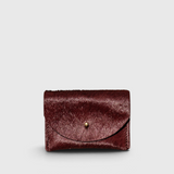 JONES + CO plum cowhide cardholder with a solid brass fastener, featuring a compact design for cards and cash.