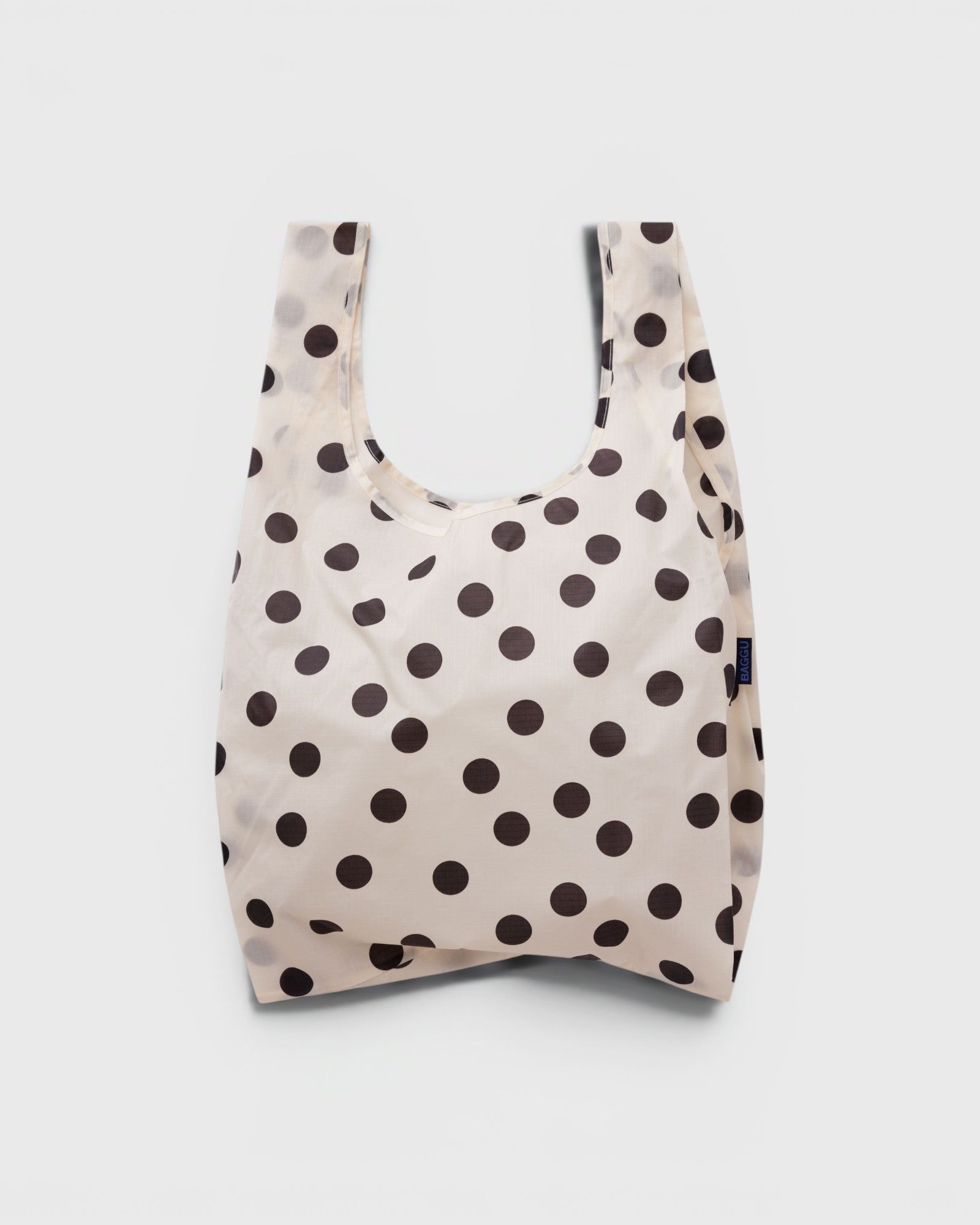 JONES + CO Standard Baggu reusable tote in cream nylon with a black polka dot pattern.