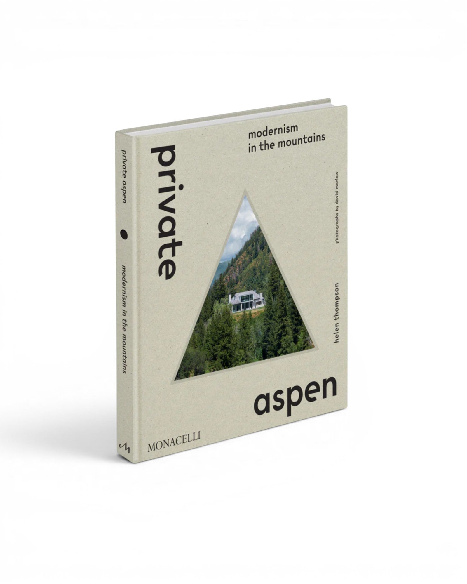 JONES + CO Private Aspen coffee table book featuring a triangular mountain home cutout on a beige hardcover.