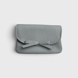 JONES + CO Provence Blue leather petite case with a front flap, knotted bow detail, and hidden magnetic closure.