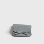 JONES + CO Provence Blue leather petite case with a front flap, knotted bow detail, and hidden magnetic closure.