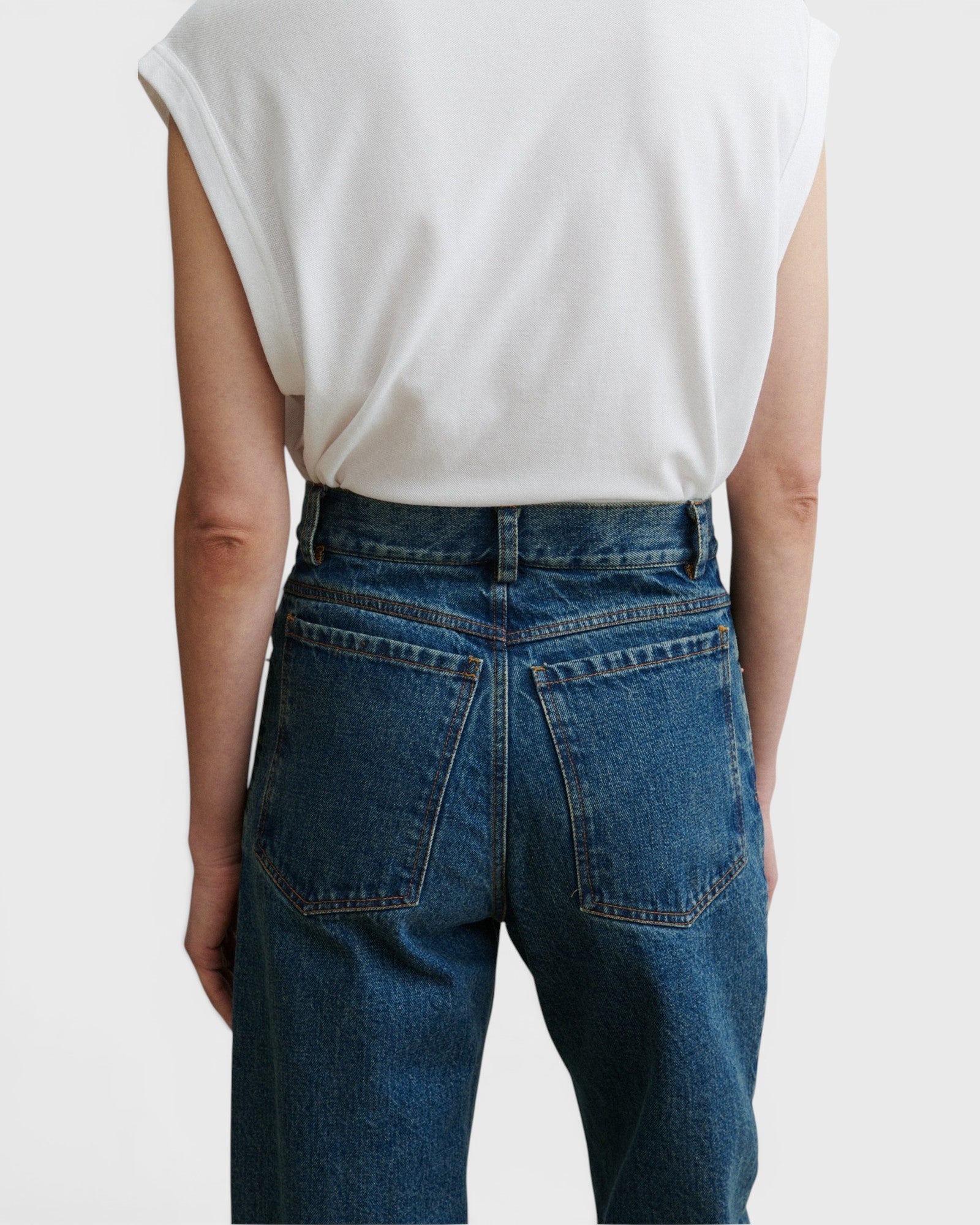 JONES + CO Puerto high-rise straight leg jeans in aged indigo cotton denim, back view on model