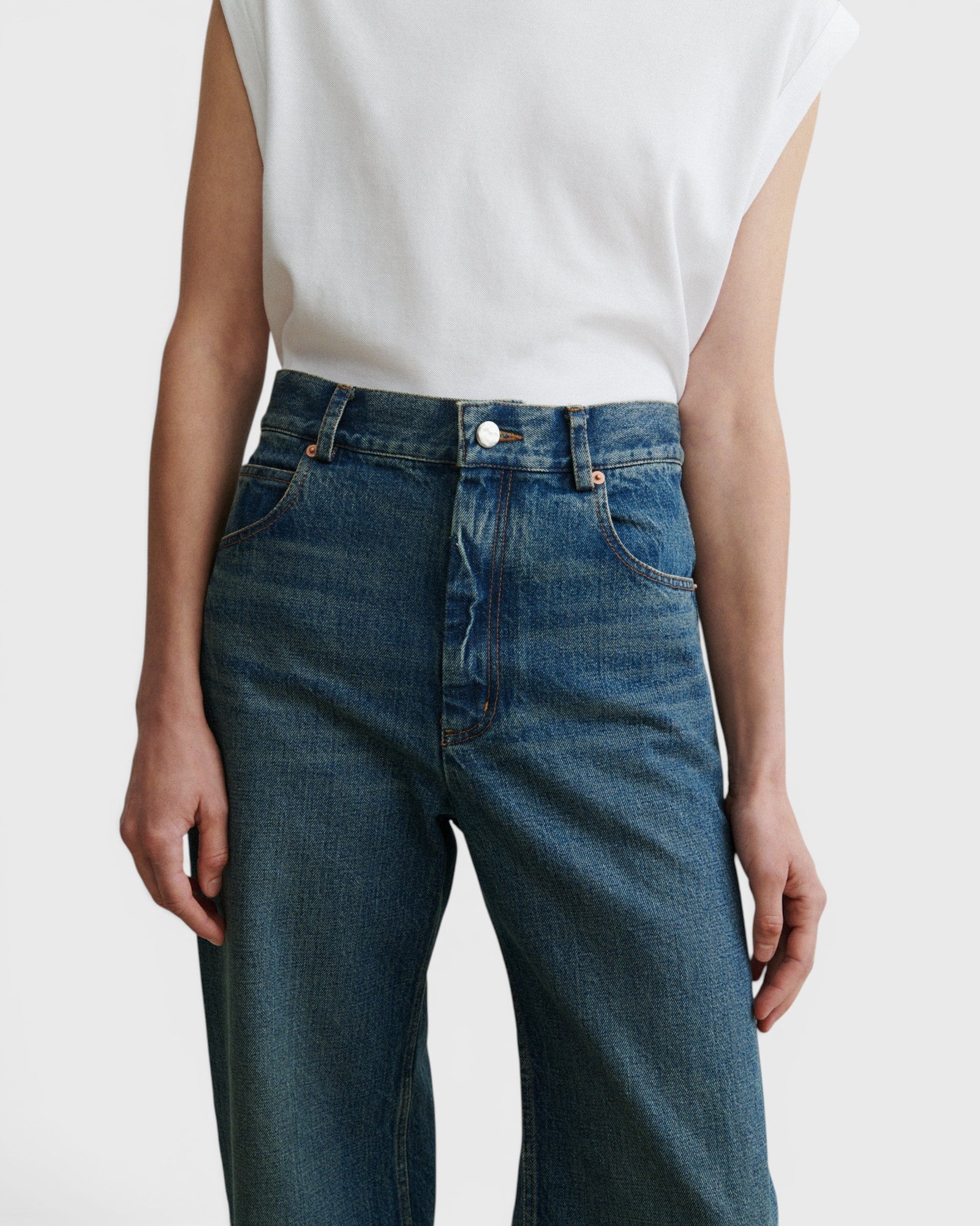 JONES + CO Puerto high-rise straight leg jeans in aged indigo cotton denim with a classic five-pocket design.