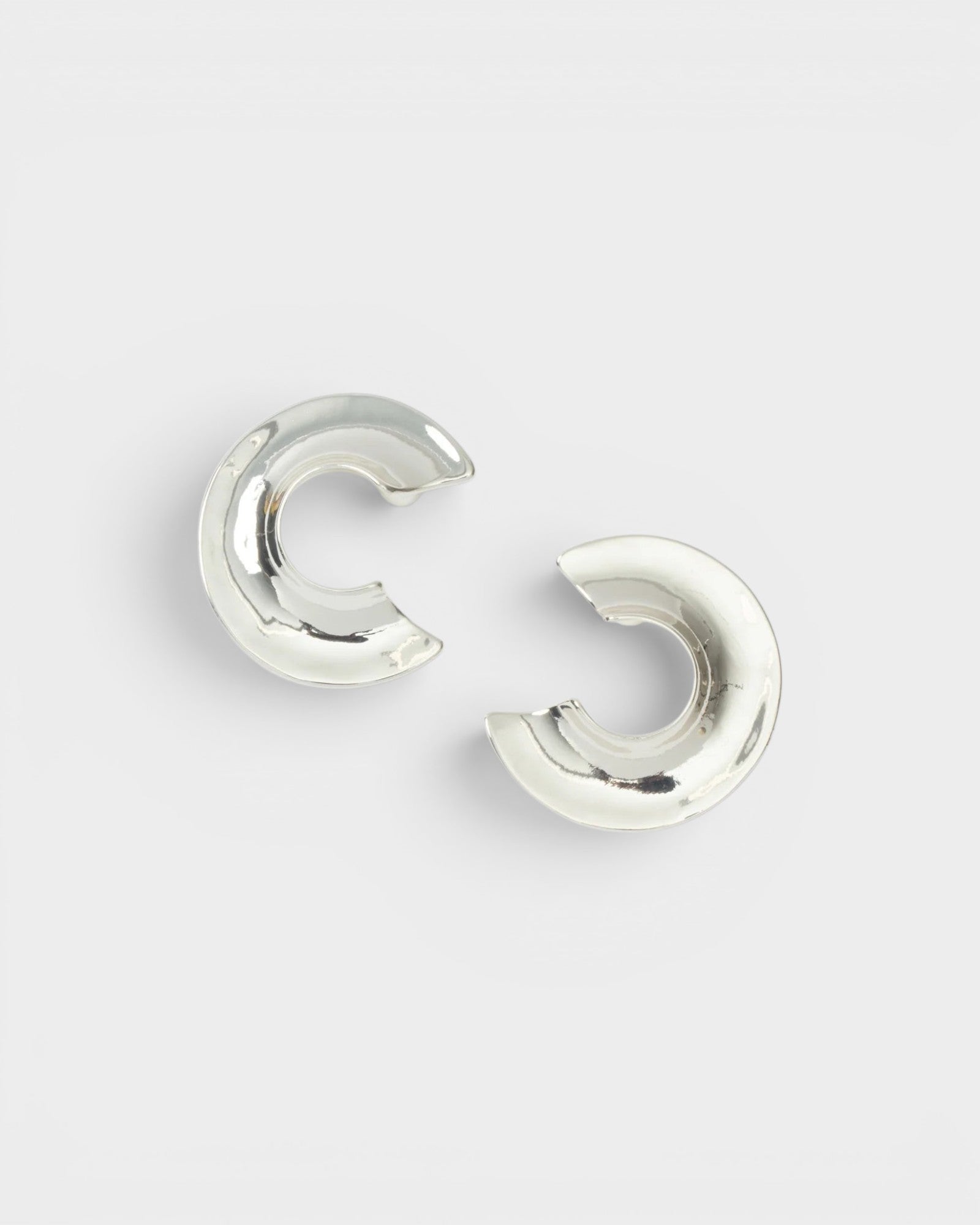 JONES + CO Rail chunky three-quarter carved hoop earrings in polished silver-plated brass.