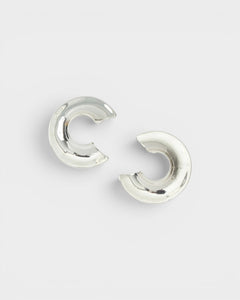 JONES + CO Rail chunky three-quarter carved hoop earrings in polished silver-plated brass.