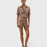 JONES + CO Raya polo top in Lais stripe crochet knit with collared neckline and button closure on a model