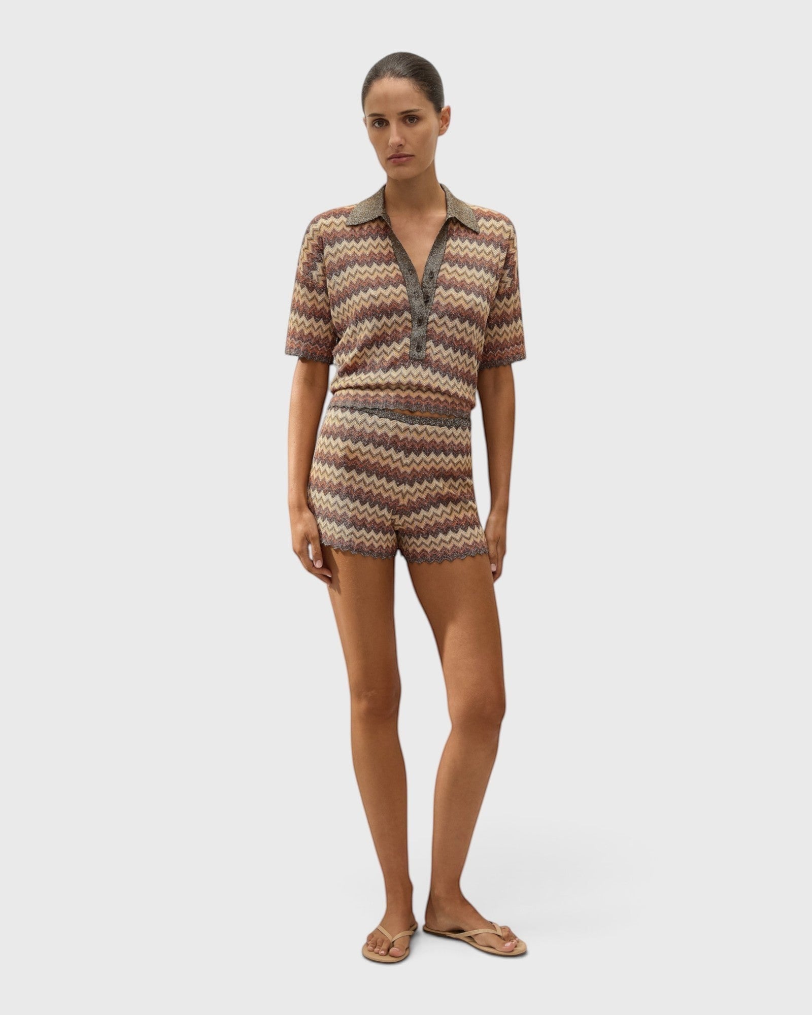 JONES + CO Raya polo top in Lais stripe crochet knit with collared neckline and button closure on a model