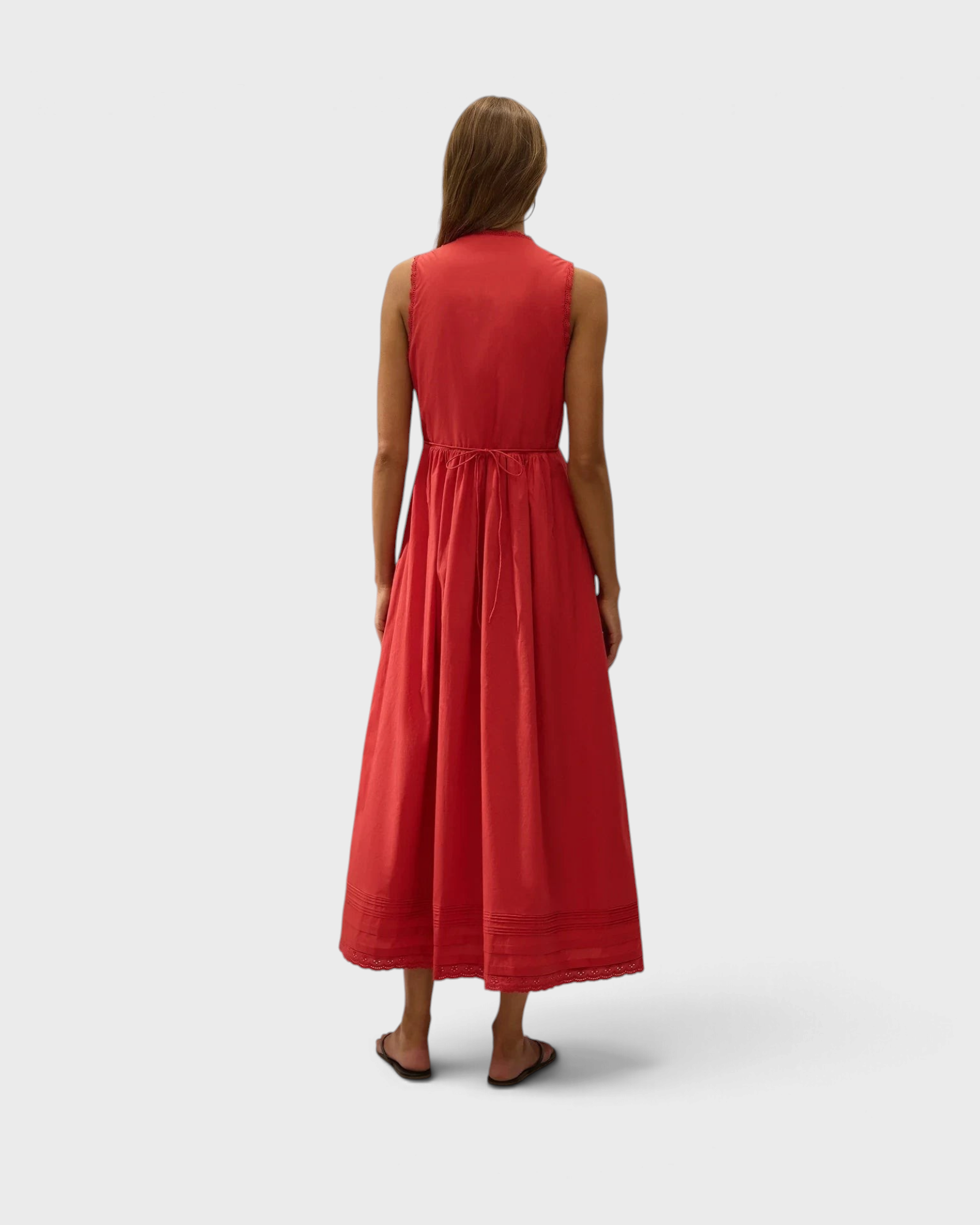 JONES + CO red cotton poplin midi dress with broderie lace trim and pintuck hem details, back view on a model.