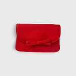JONES + CO red leather petite case featuring a front flap with a decorative knotted bow and magnetic closure.