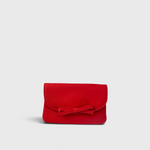 JONES + CO red leather petite case featuring a front flap with a decorative knotted bow and magnetic closure.