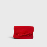 JONES + CO red leather petite case featuring a front flap with a decorative knotted bow and magnetic closure.