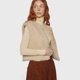 JONES + CO reversible short vest in oatmeal beige with quilted wool blend and soft faux fur lining on a model