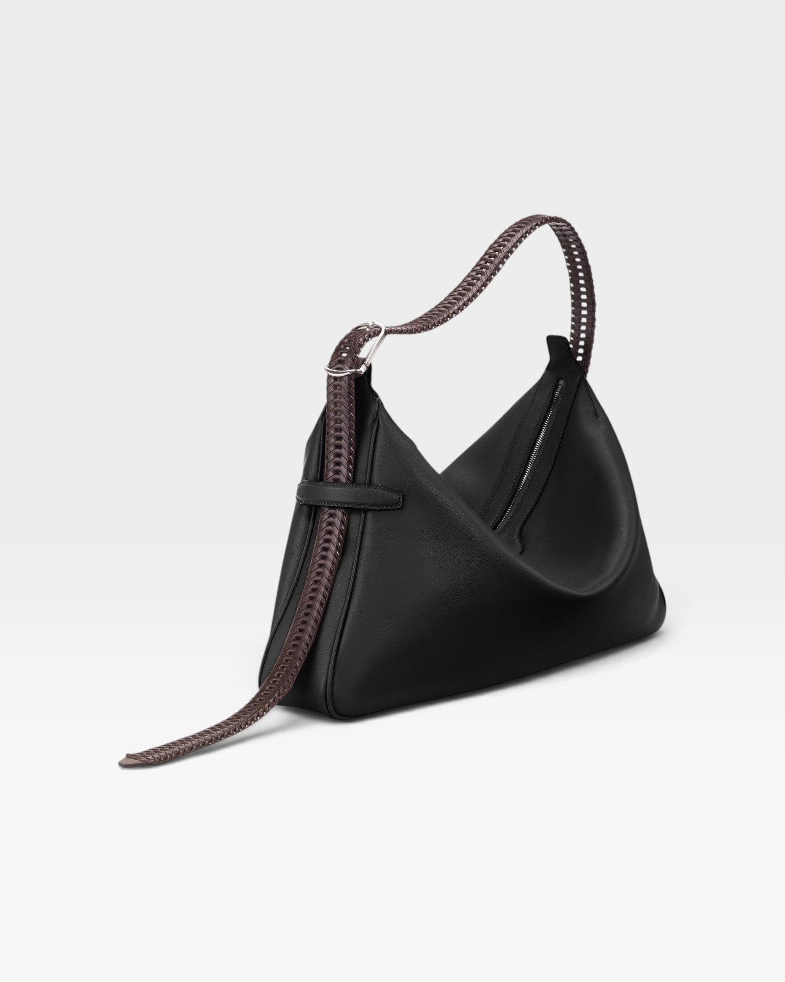 JONES + CO Rider M Elche black leather bag with a unique architectural shape and a decorative hand-braided strap.