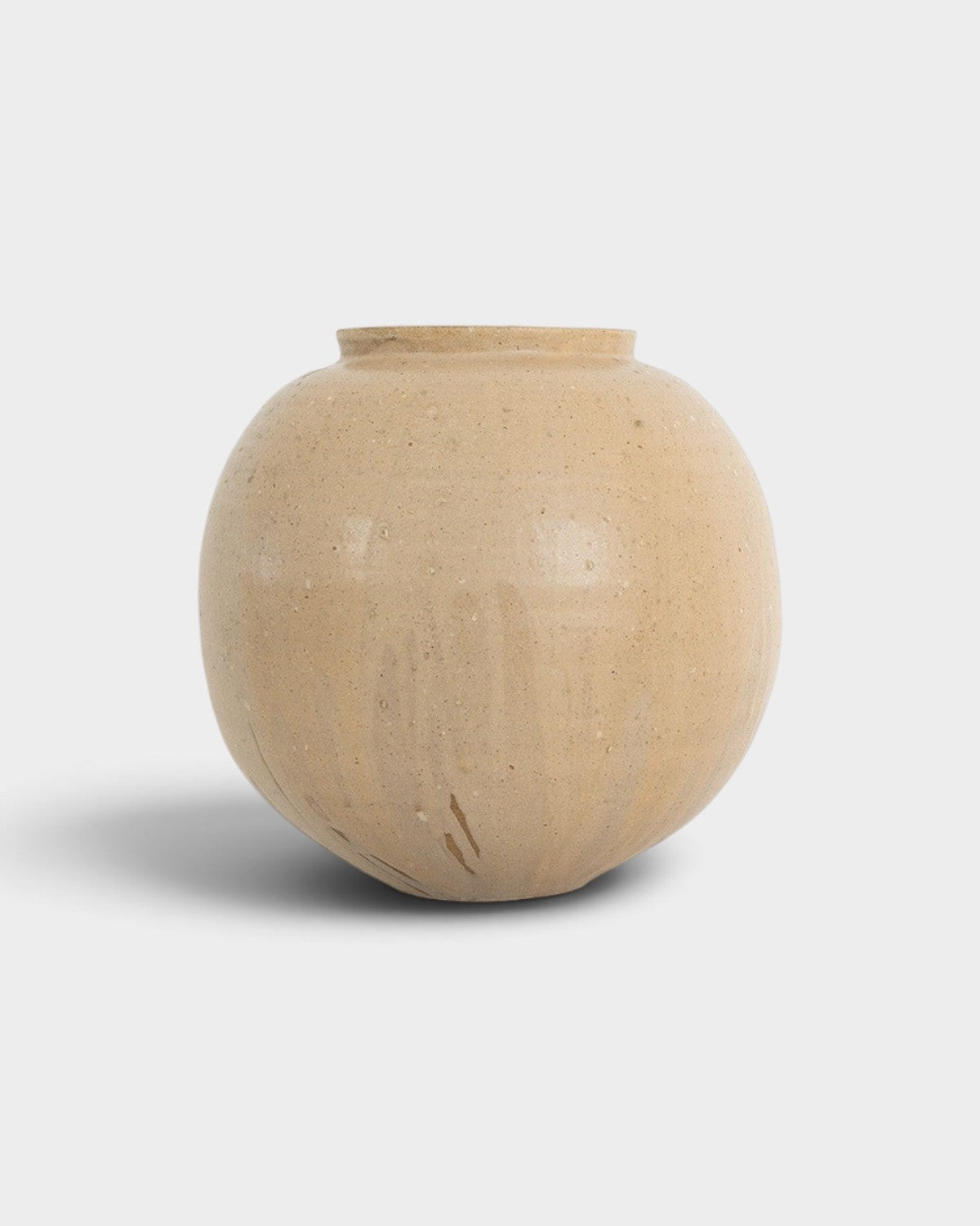 JONES + CO handthrown ceramic vase in a round, beige speckled finish, perfect as a sculptural home decor piece.