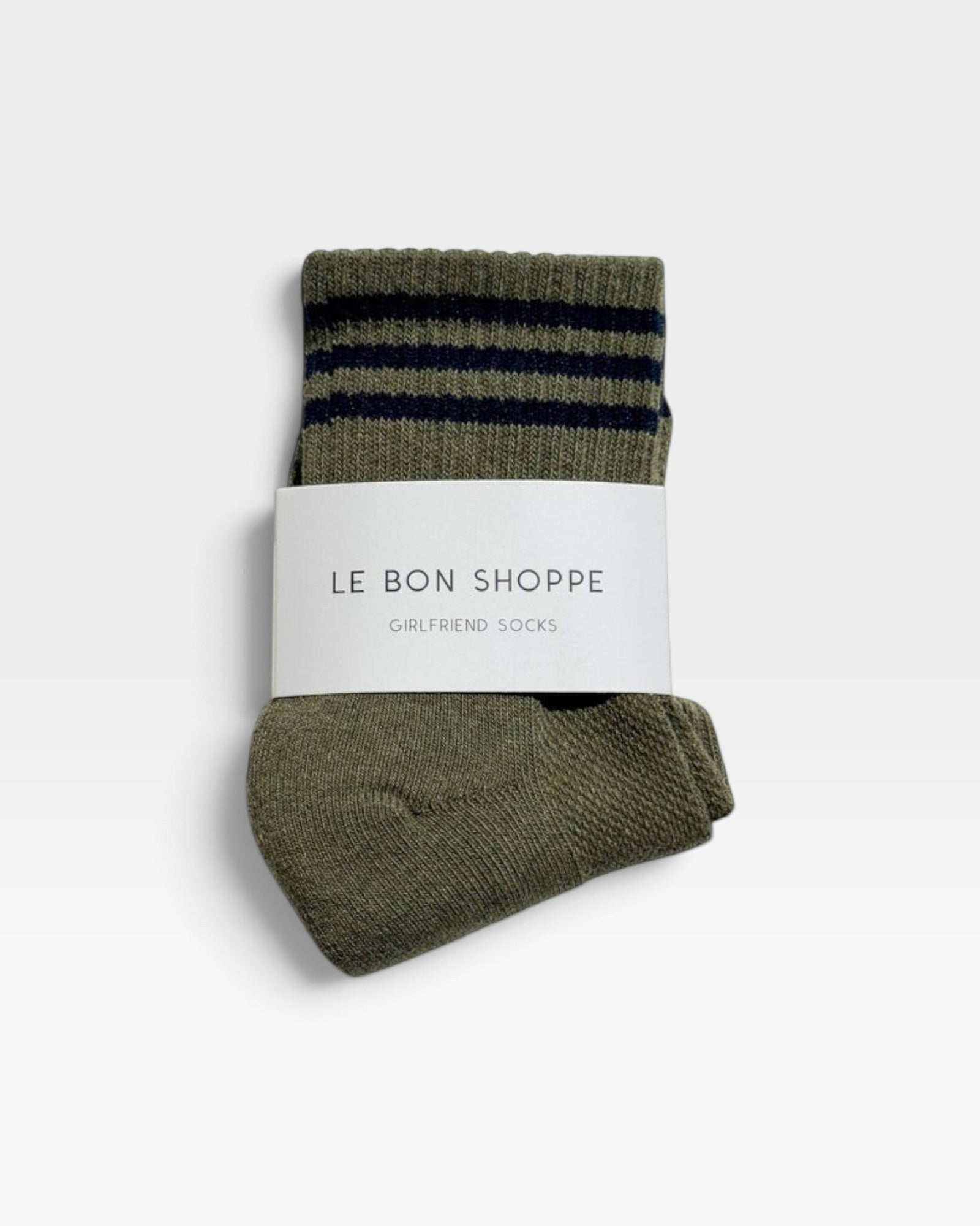JONES + CO Le Bon Shoppe sage green crew socks with navy blue varsity stripes in branded paper packaging