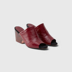 JONES + CO Rachel Comey scarlet leather wedge mules with an angular peep toe and sculptural clog-inspired heel.
