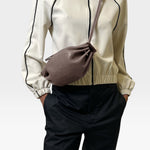 JONES + CO Bon-Bon Cords bag in shiny taupe Italian leather with a pleated design and double cord strap.