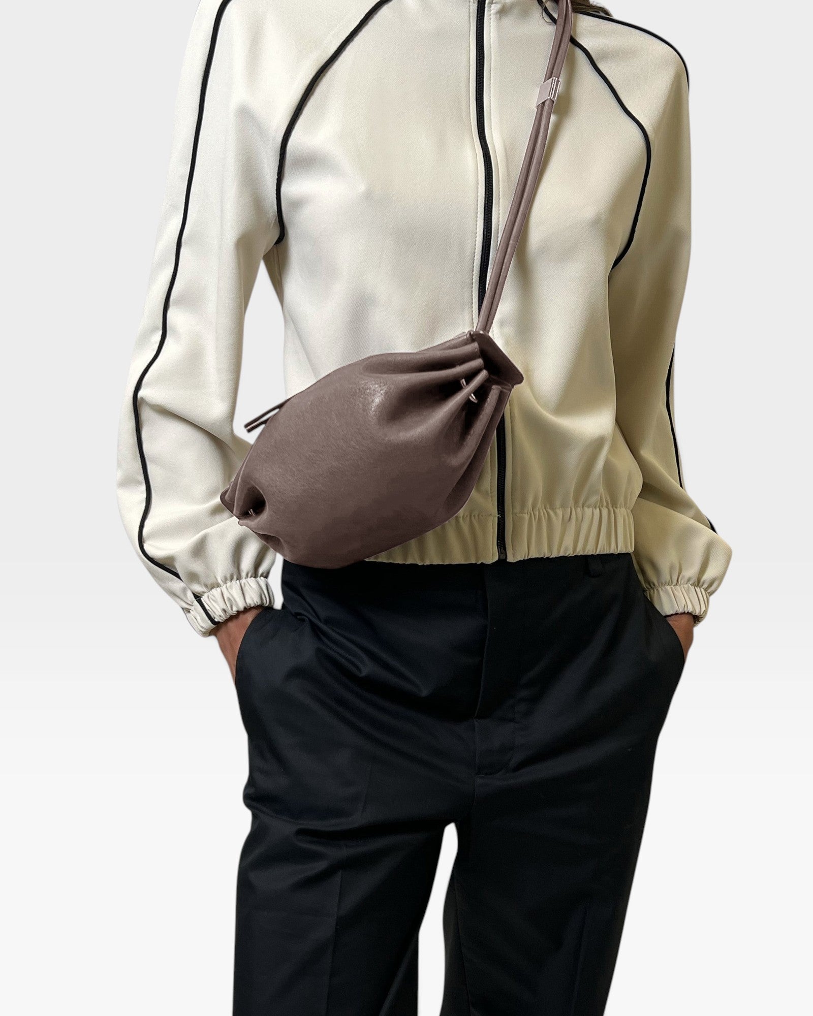JONES + CO Bon-Bon Cords bag in shiny taupe Italian leather with a pleated design and double cord strap.