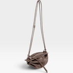 JONES + CO Bon-Bon Cords bag in shiny taupe Italian calf leather with a unique pleated design and double cord strap.