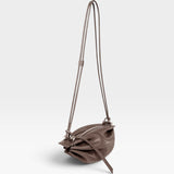 JONES + CO Bon-Bon Cords bag in shiny taupe Italian calf leather with a unique pleated design and double cord strap.