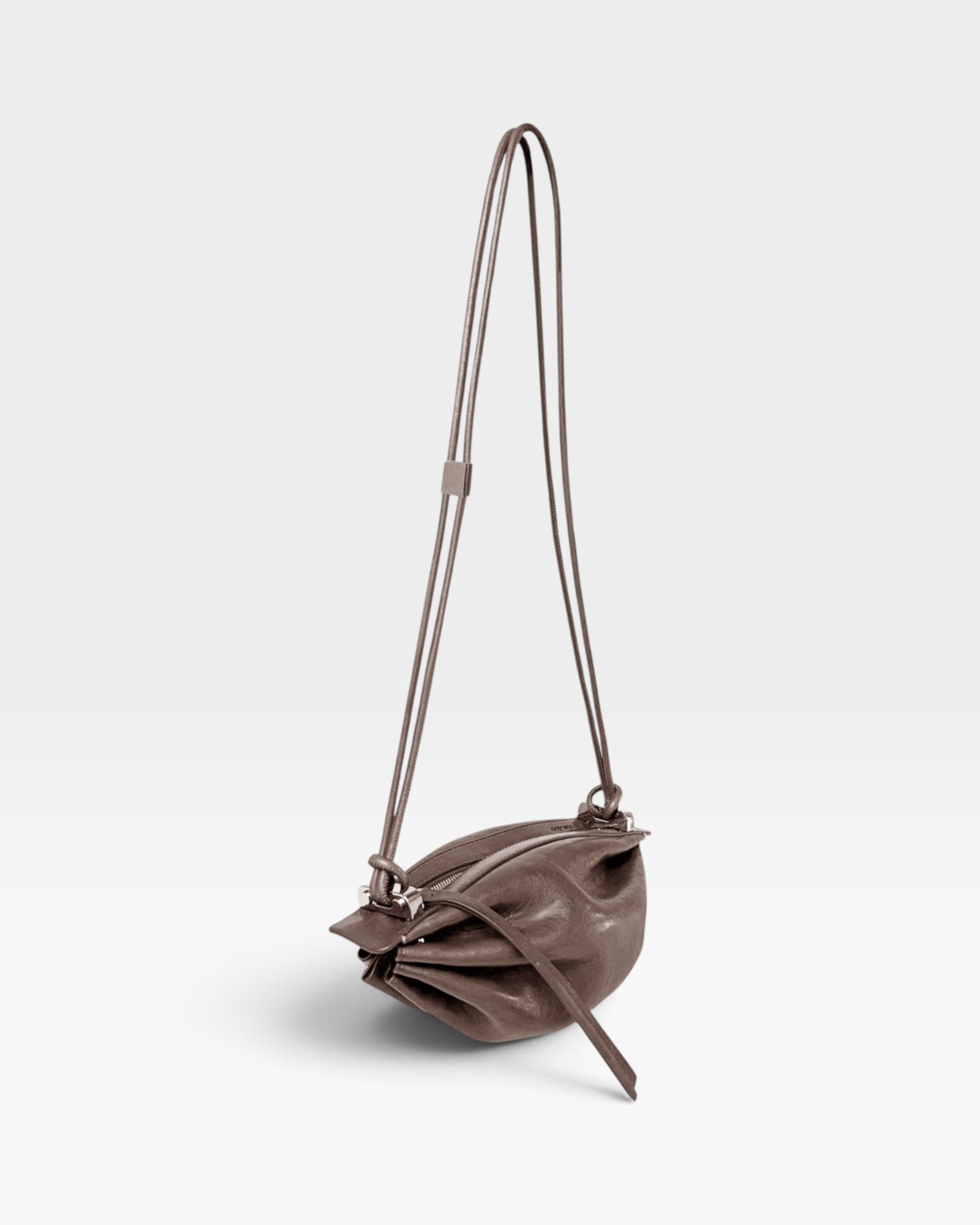JONES + CO Bon-Bon Cords bag in shiny taupe Italian calf leather with a unique pleated design and double cord strap.
