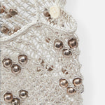 JONES + CO Mini Web Bag in silver featuring intricate macrame leather weaving and metallic bamboo bead details.